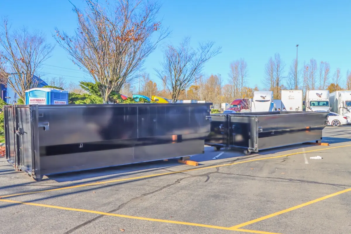 Professional dumpster rental service with roll-off container on residential driveway in Ligonier